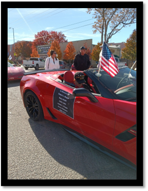 A red sports car with a flag on the roof

AI-generated content may be incorrect.