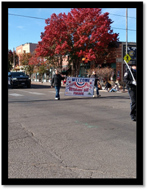 A person walking in the street with a sign

AI-generated content may be incorrect.