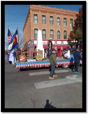 A parade float with flags and people in the street

AI-generated content may be incorrect.