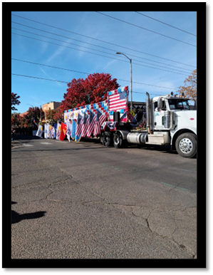 A truck with a flag on the side with Cadillac Ranch in the background

AI-generated content may be incorrect.