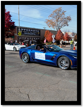 A blue sports car with a white sign on it

AI-generated content may be incorrect.