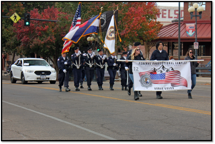 A group of people marching in the street holding flags

Description automatically generated with medium confidence