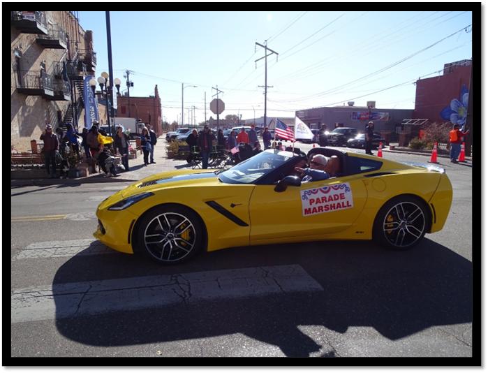 A yellow sports car on a street

Description automatically generated