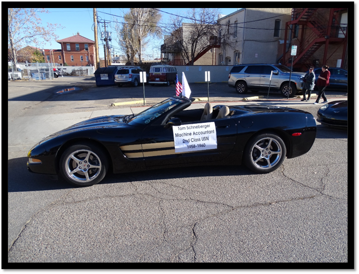 A black sports car with a sign on the side

Description automatically generated