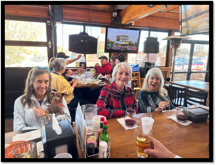 A group of women sitting at a table

Description automatically generated