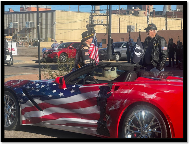 A red car with a flag painted on it

Description automatically generated