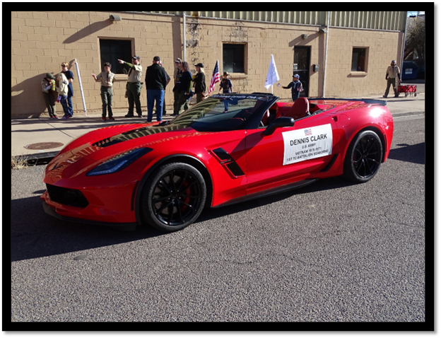 A red sports car with a sign on it

Description automatically generated