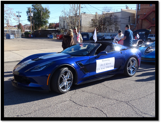 A blue sports car with a sign on it

Description automatically generated