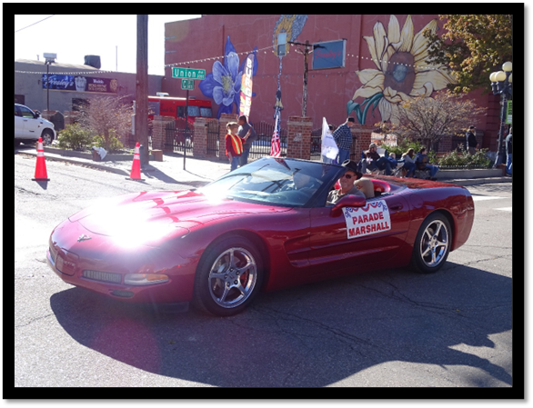 A red car with a banner on the side

Description automatically generated