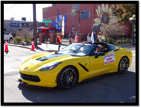 A yellow sports car with a sign on the side

Description automatically generated
