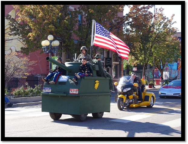 A military vehicle with people on it

Description automatically generated