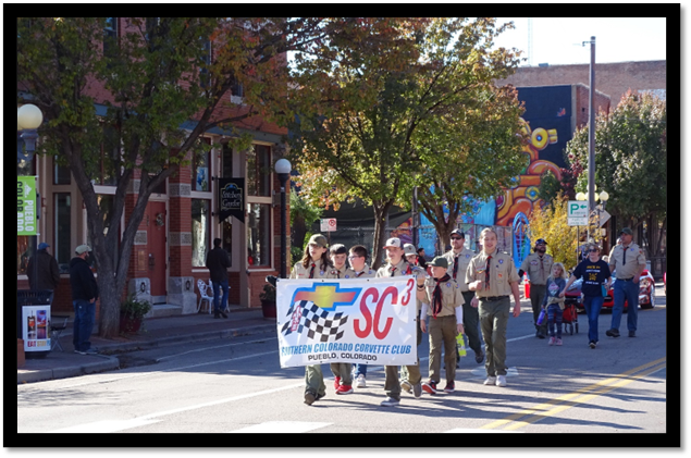 A group of people marching in a parade

Description automatically generated