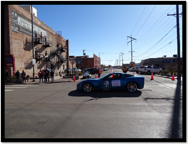 A blue car on a street

Description automatically generated