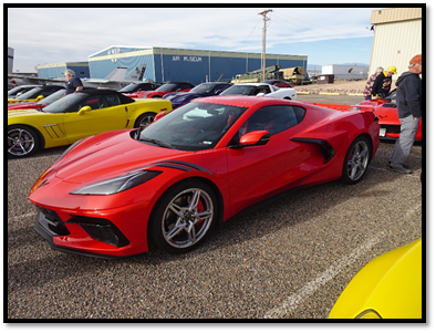 A red sports car parked next to other cars

Description automatically generated with low confidence
